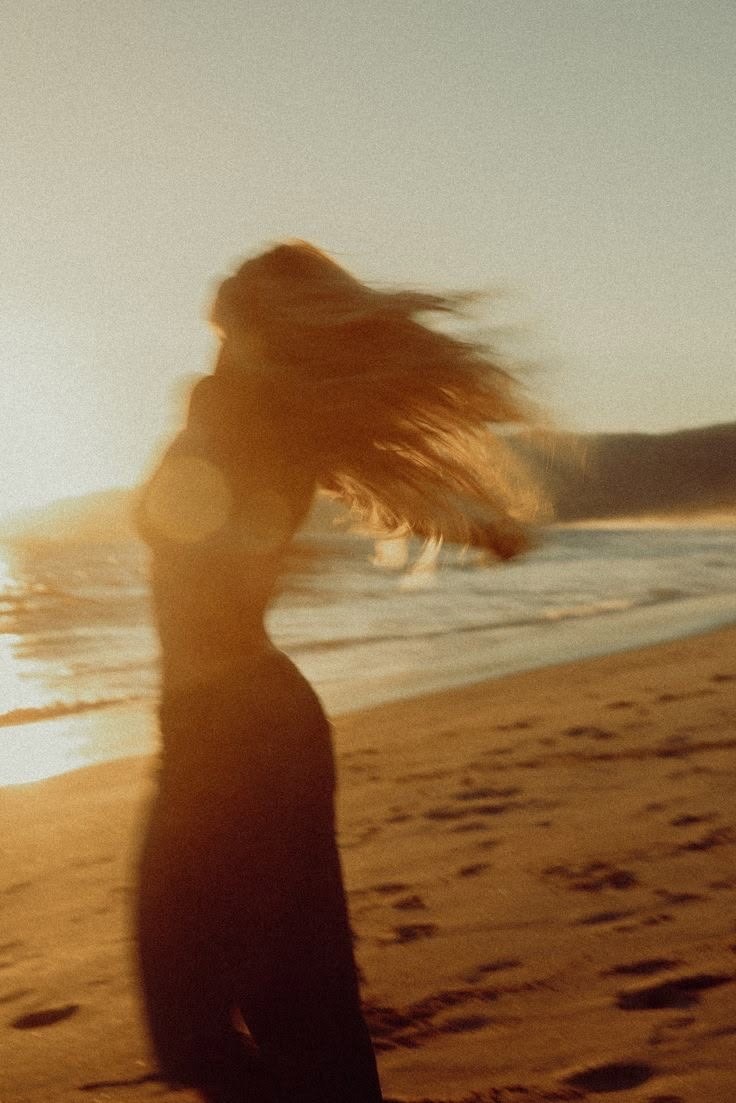 Woman on the beach with hair blowing in the wind